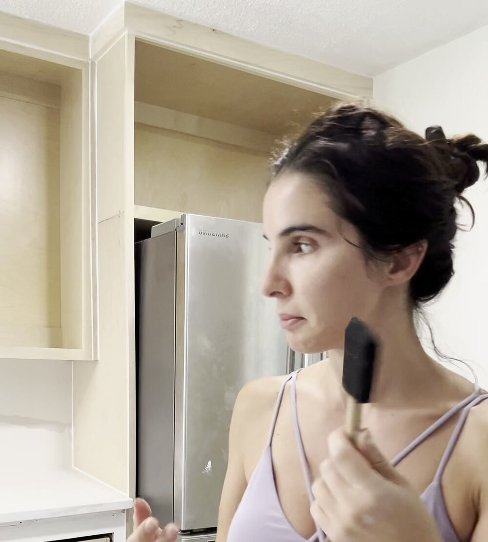 Bea, founder of Second Coat Studio, on a job site with a brush