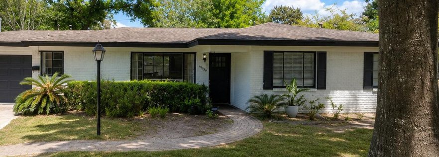 The same house after painting the brick white with black trim