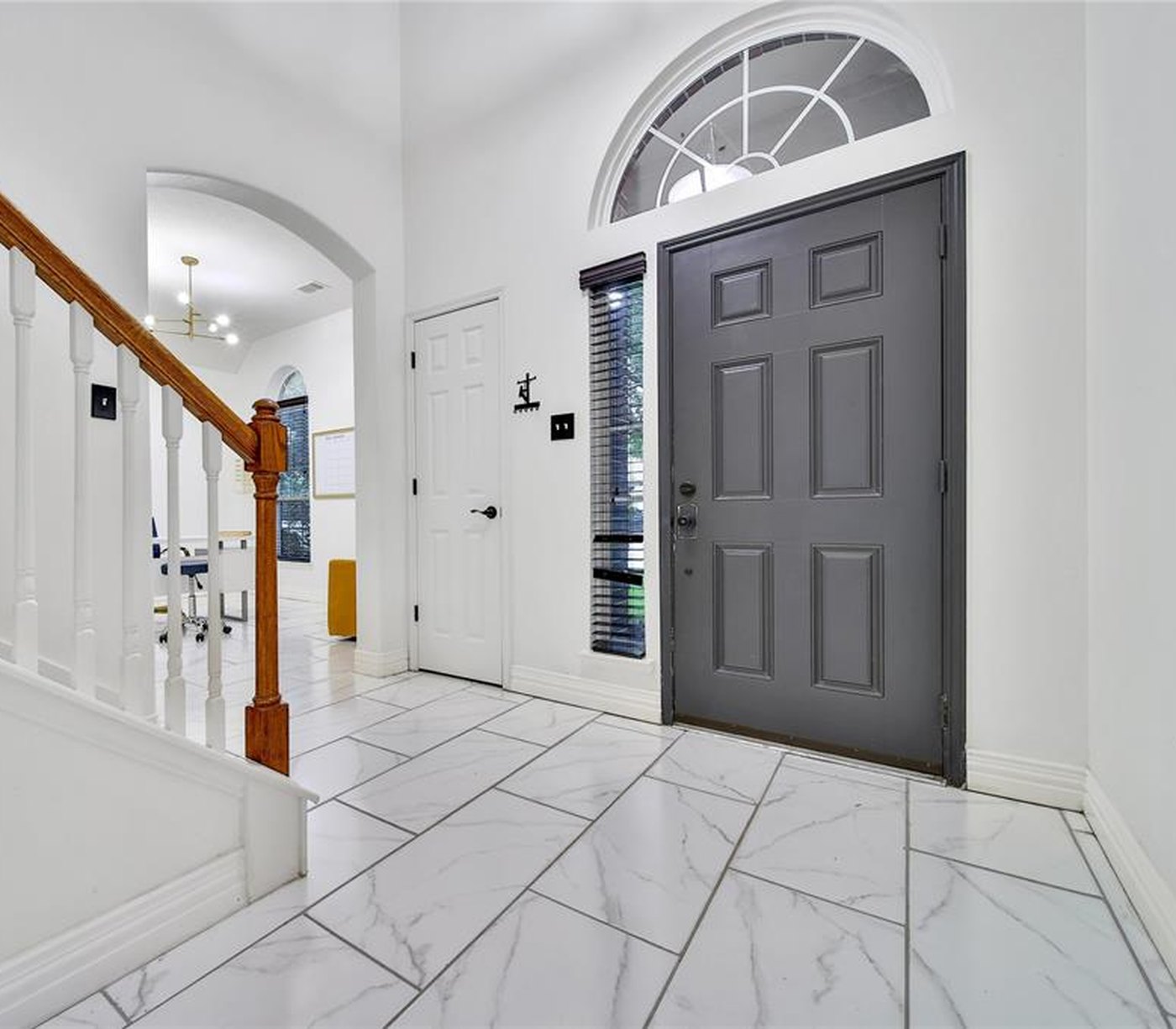 Entry with the front door in a flat gray and white trim