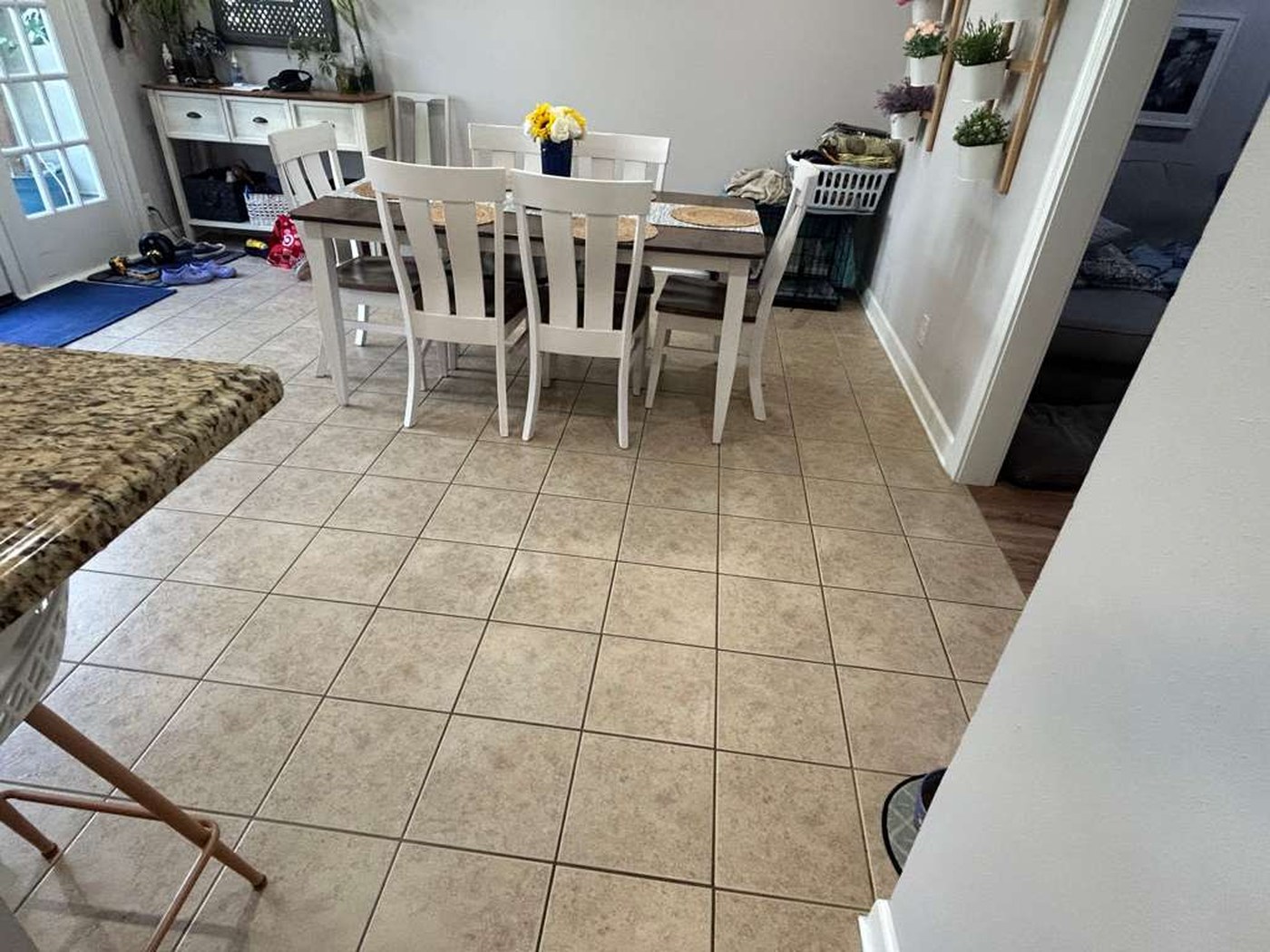 Dining area with cream ceramic tile floor and a dining table