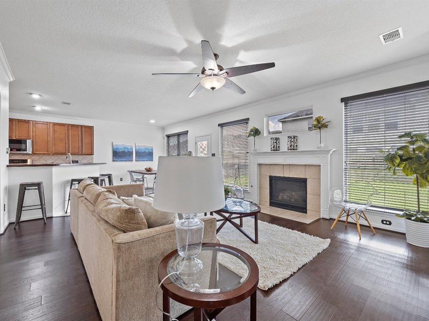 The same living room finished in a light neutral with the fireplace and trim in white